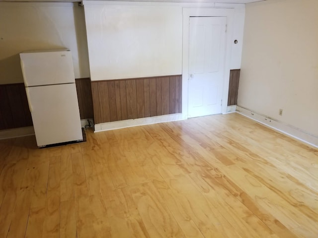 503-505 E 2nd St Unit 503, Chillicothe, OH 45601 - below grade area featuring freestanding refrigerator, light wood-type flooring, a wainscoted wall, wooden walls, and baseboards