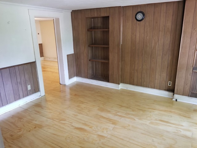 503-505 E 2nd St Unit 503, Chillicothe, OH 45601 - spare room with built in shelves, wooden walls, light wood-type flooring, and baseboards