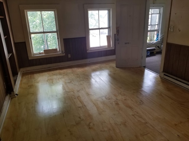 503-505 E 2nd St Unit 503, Chillicothe, OH 45601 - empty room with hardwood / wood-style floors, wainscoting, healthy amount of natural light, and baseboard heating