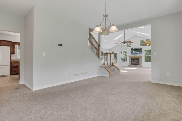 7485 Sugar Grove Rd SE, Sugar Grove, OH 43155 - unfurnished living room with light colored carpet, stairway, ceiling fan, a stone fireplace, and high vaulted ceiling