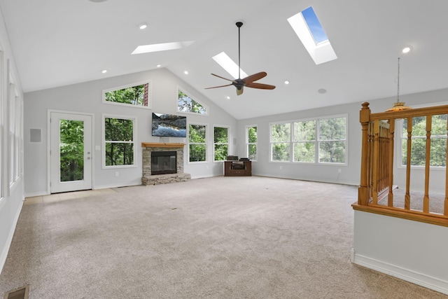 7485 Sugar Grove Rd SE, Sugar Grove, OH 43155 - unfurnished living room featuring a skylight, high vaulted ceiling, a stone fireplace, baseboards, and carpet