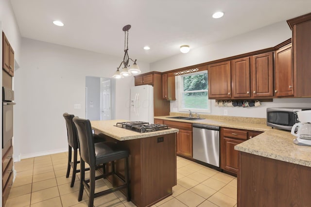 7485 Sugar Grove Rd SE, Sugar Grove, OH 43155 - kitchen featuring appliances with stainless steel finishes, light countertops, a sink, light tile patterned flooring, and decorative light fixtures