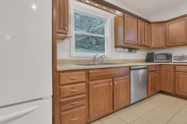 7485 Sugar Grove Rd SE, Sugar Grove, OH 43155 - kitchen featuring stainless steel appliances, a sink, light countertops, brown cabinetry, and light tile patterned floors