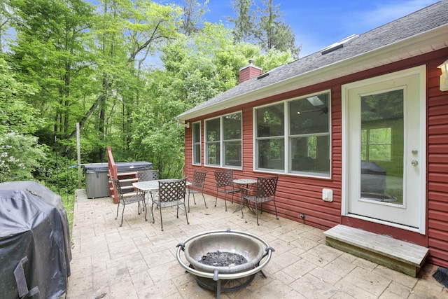 7485 Sugar Grove Rd SE, Sugar Grove, OH 43155 - view of patio featuring outdoor dining area, an outdoor fire pit, a hot tub, and a grill