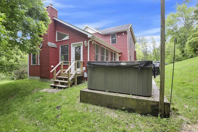 7485 Sugar Grove Rd SE, Sugar Grove, OH 43155 - back of property with a hot tub, a chimney, and a lawn