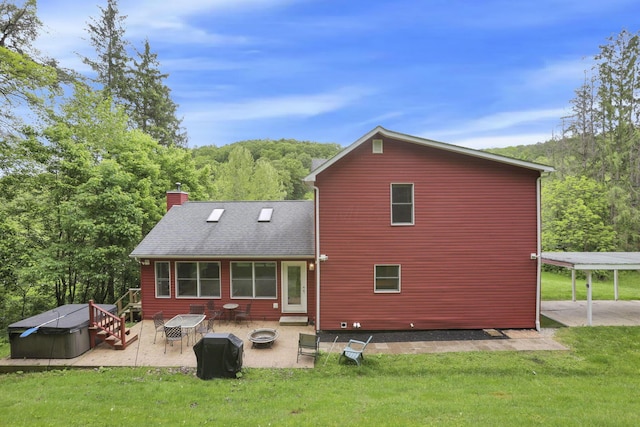 7485 Sugar Grove Rd SE, Sugar Grove, OH 43155 - rear view of property featuring a hot tub, a chimney, a patio, a lawn, and a wooded view