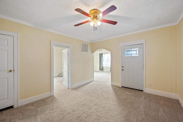 482 E Farming St, Marion, OH 43302 - carpeted foyer with a ceiling fan, ornamental molding, arched walkways, a textured ceiling, and baseboards