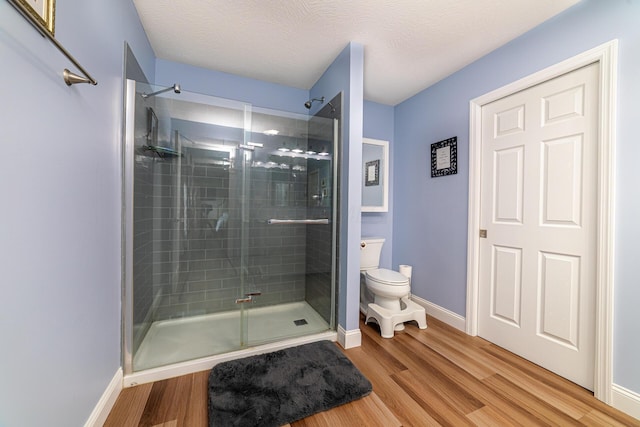 471 Quaker Trce, Marengo, OH 43334 - bathroom with toilet, a stall shower, wood finished floors, and baseboards