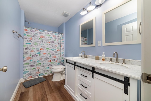 471 Quaker Trce, Marengo, OH 43334 - bathroom featuring wood finished floors, double vanity, toilet, curtained shower, and baseboards