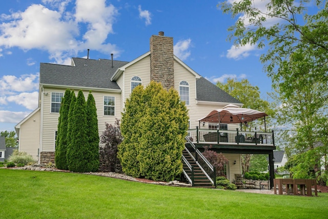 161 Calumet Ct, Ostrander, OH 43061 - rear view of house with a wooden deck, a chimney, a yard, stairs, and a shingled roof