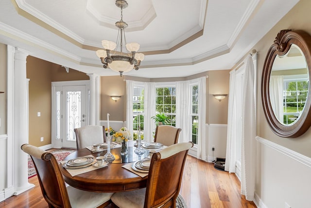 161 Calumet Ct, Ostrander, OH 43061 - dining space with a raised ceiling, ornate columns, healthy amount of natural light, and crown molding