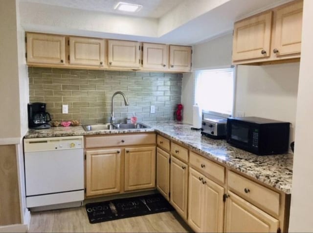661 E 11th Ave, Columbus, OH 43211 - kitchen with white dishwasher, light brown cabinets, a sink, black microwave, and light wood-type flooring