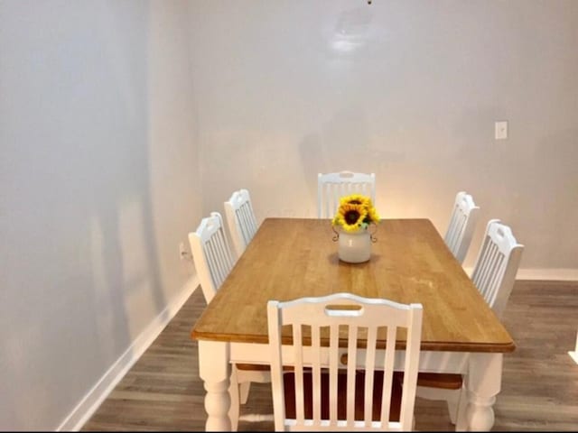661 E 11th Ave, Columbus, OH 43211 - dining area featuring baseboards and wood finished floors