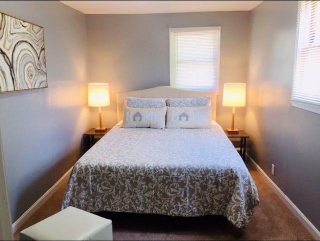 661 E 11th Ave, Columbus, OH 43211 - bedroom with multiple windows, baseboards, and carpet