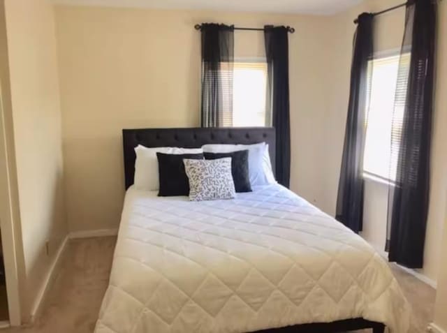 661 E 11th Ave, Columbus, OH 43211 - bedroom featuring multiple windows, baseboards, and carpet floors
