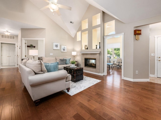 38 Ironclad Dr, Columbus, OH 43213 - living area with wood-type flooring, a multi sided fireplace, ceiling fan, high vaulted ceiling, and baseboards