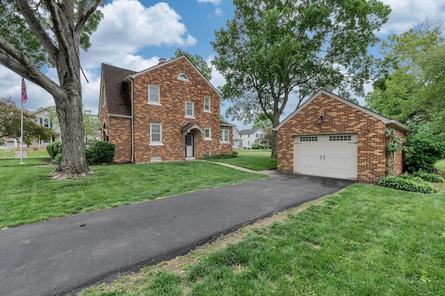750 E Allen St, Lancaster, OH 43130 - view of front of home featuring brick siding, a front yard, driveway, and a detached garage