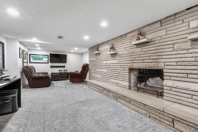 750 E Allen St, Lancaster, OH 43130 - carpeted living room with recessed lighting, a fireplace, and a textured ceiling