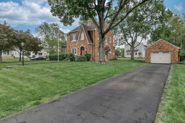 750 E Allen St, Lancaster, OH 43130 - view of front of home with brick siding, a detached garage, asphalt driveway, a chimney, and a front yard