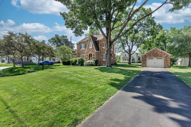 750 E Allen St, Lancaster, OH 43130 - view of front of house featuring an outdoor structure, a detached garage, brick siding, a chimney, and a residential view
