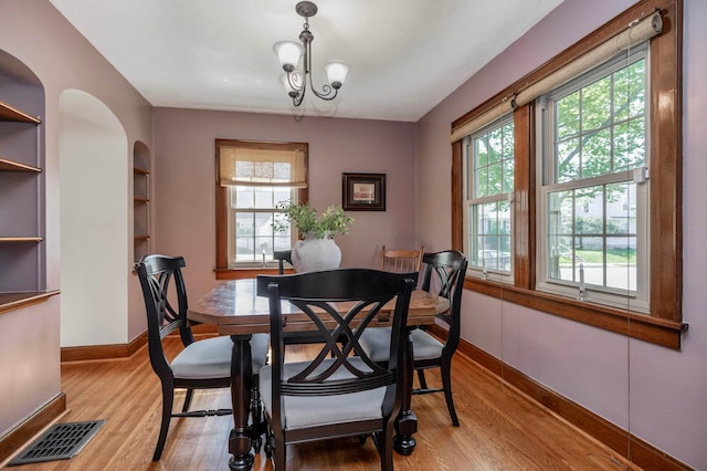750 E Allen St, Lancaster, OH 43130 - dining space featuring plenty of natural light, light wood-style floors, built in shelves, and a chandelier