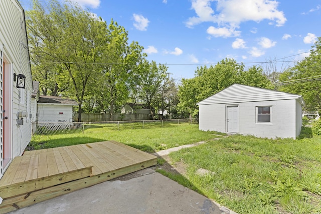 3129 Mcguffey Rd, Columbus, OH 43224 - fenced backyard featuring a wooden deck and an outbuilding