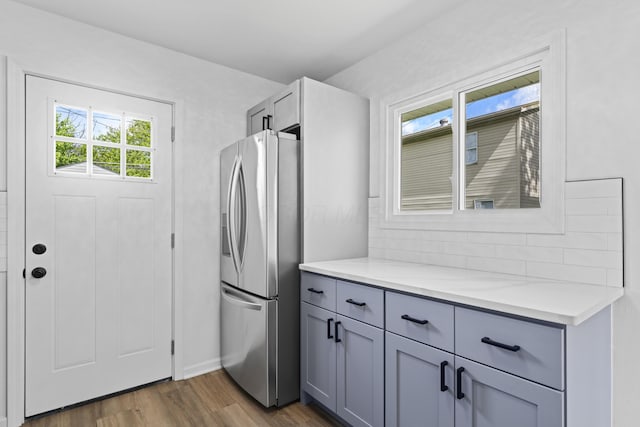 3129 Mcguffey Rd, Columbus, OH 43224 - kitchen featuring stainless steel fridge with ice dispenser, gray cabinets, and dark wood-style flooring