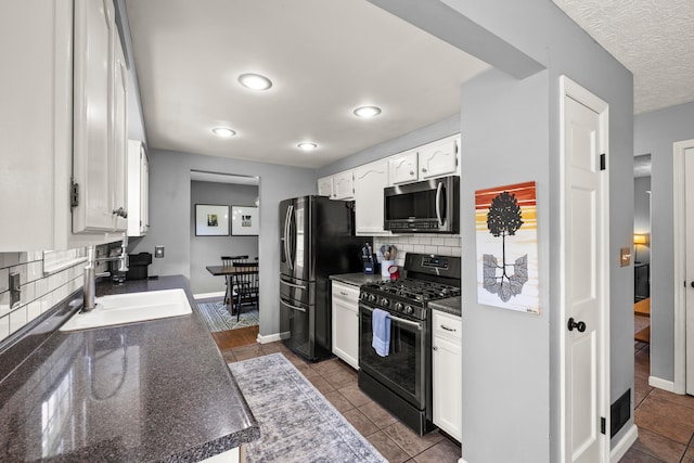 1997 Sutter Pkwy, Dublin, OH 43016 - kitchen with appliances with stainless steel finishes, a sink, dark countertops, white cabinets, and recessed lighting
