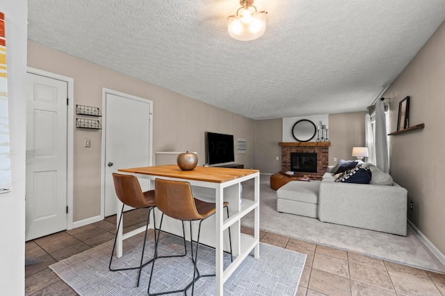 1997 Sutter Pkwy, Dublin, OH 43016 - tiled dining space featuring a fireplace, a textured ceiling, and baseboards