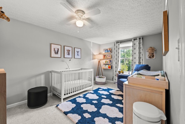 1997 Sutter Pkwy, Dublin, OH 43016 - carpeted bedroom featuring a textured ceiling, a nursery area, a ceiling fan, and baseboards