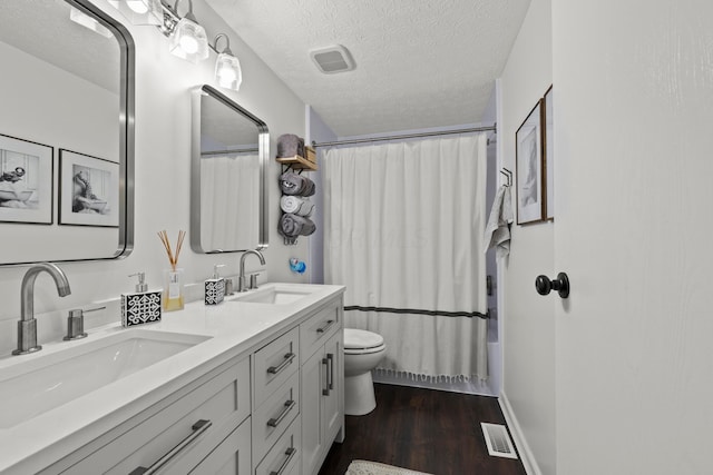 1997 Sutter Pkwy, Dublin, OH 43016 - full bath with double vanity, wood finished floors, toilet, shower / bath combination with curtain, and a textured ceiling