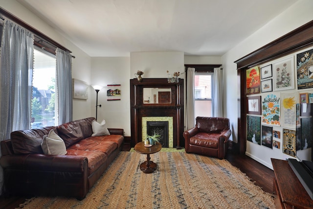 2045 N 4th St, Columbus, OH 43201 - living area with wood finished floors, a brick fireplace, and baseboards