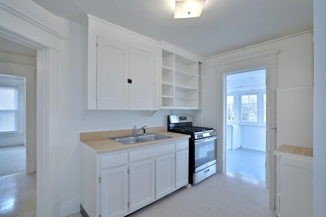 2045 N 4th St, Columbus, OH 43201 - kitchen with stainless steel gas range oven, a sink, white cabinetry, open shelves, and light countertops