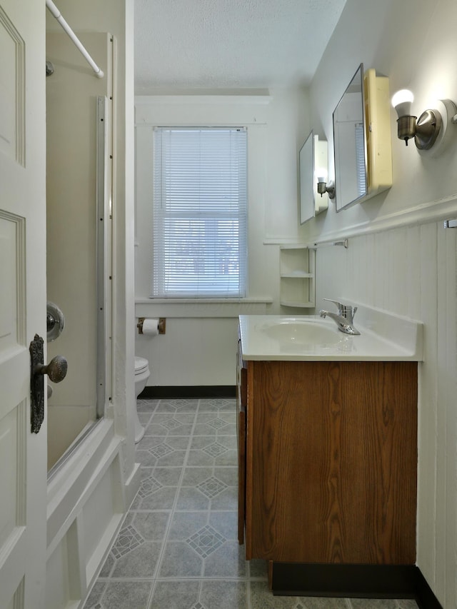 2045 N 4th St, Columbus, OH 43201 - full bath featuring vanity, tub / shower combination, toilet, a textured ceiling, and tile patterned flooring