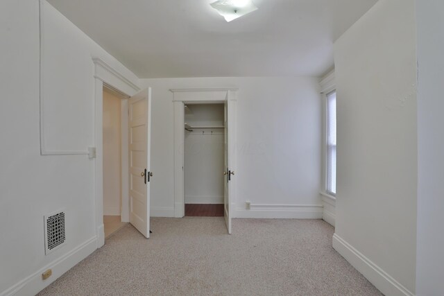 2045 N 4th St, Columbus, OH 43201 - unfurnished bedroom with light carpet, baseboards, and a closet