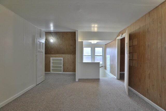 2045 N 4th St, Columbus, OH 43201 - carpeted empty room with wooden walls, built in shelves, and baseboards