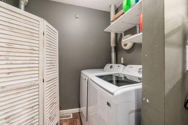 4419 Trindel Way, Columbus, OH 43231 - laundry room with independent washer and dryer, wood finished floors, baseboards, and a textured ceiling