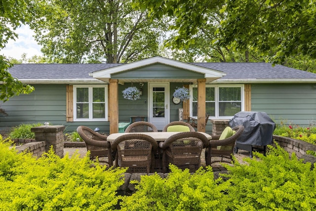 21171 River Rd, Circleville, OH 43113 - rear view of house with roof with shingles and outdoor dining area
