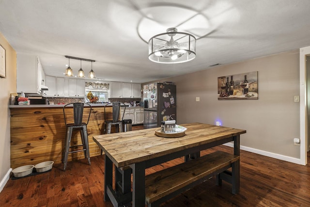 21171 River Rd, Circleville, OH 43113 - dining space featuring baseboards and dark wood finished floors