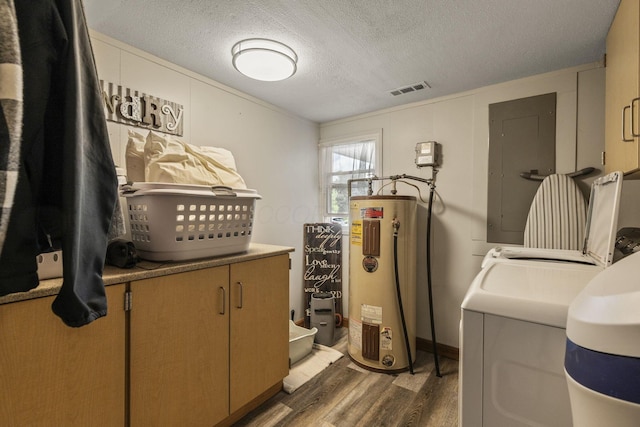 21171 River Rd, Circleville, OH 43113 - laundry room featuring water heater, washing machine and dryer, wood finished floors, electric panel, and a textured ceiling