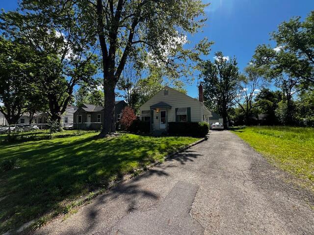 2428 Bancroft St, Columbus, OH 43211 - view of front of property featuring a front yard, driveway, and a chimney