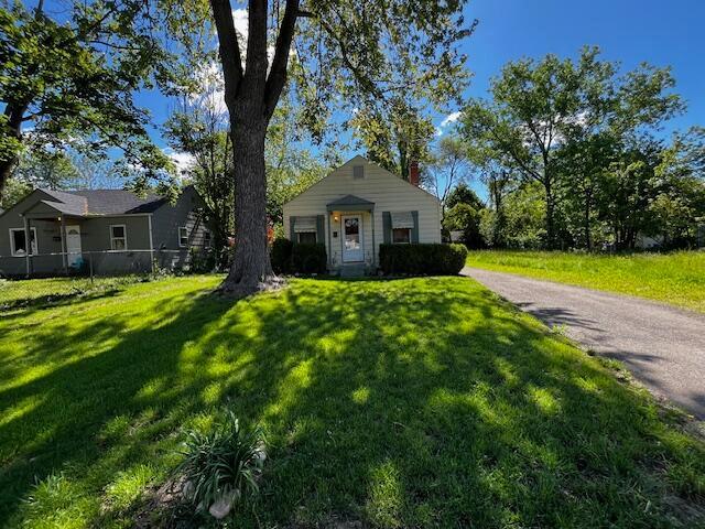 2428 Bancroft St, Columbus, OH 43211 - bungalow-style home featuring a front lawn and a chimney