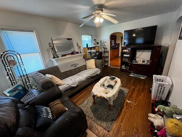 2428 Bancroft St, Columbus, OH 43211 - living area featuring arched walkways, ceiling fan, and dark wood finished floors
