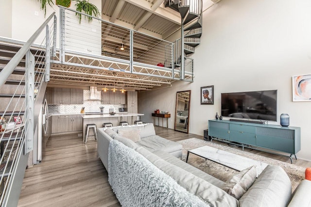 367 Auden Ave Unit 306, Columbus, OH 43215 - living area with light wood-style flooring and a towering ceiling