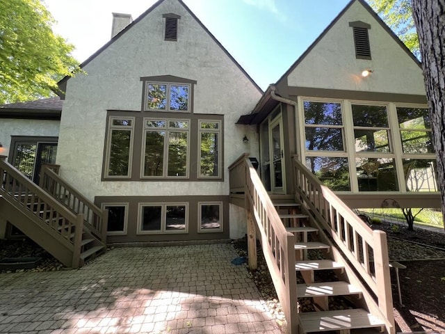 5645 Travis Pointe Ct, Westerville, OH 43082 - rear view of property with stairs, stucco siding, a patio, and a chimney