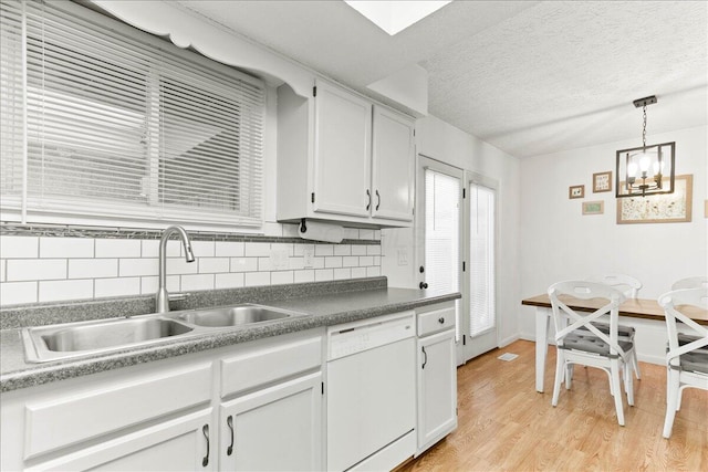 2361 Mccauley Ct, Columbus, OH 43220 - kitchen featuring dishwasher, decorative backsplash, light wood-style floors, a chandelier, and a textured ceiling