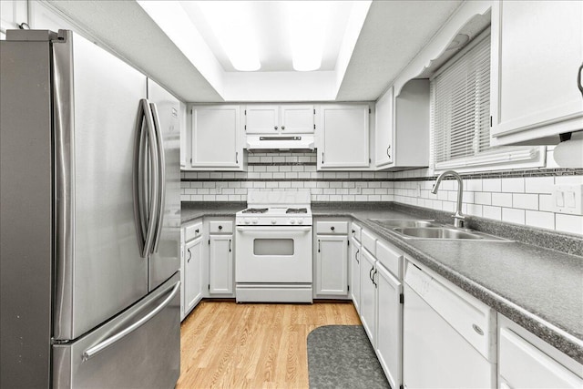 2361 Mccauley Ct, Columbus, OH 43220 - kitchen with white appliances, under cabinet range hood, dark countertops, light wood finished floors, and backsplash