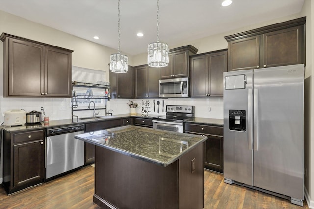 7142 Duke Dr, Canal Winchester, OH 43110 - kitchen with appliances with stainless steel finishes, a chandelier, dark brown cabinets, a sink, and recessed lighting