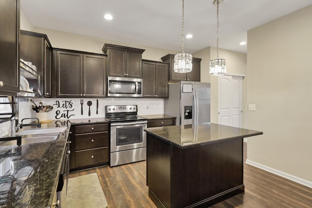 7142 Duke Dr, Canal Winchester, OH 43110 - kitchen featuring stainless steel appliances, a sink, dark brown cabinetry, a chandelier, and backsplash