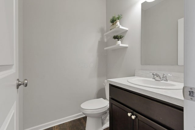 7142 Duke Dr, Canal Winchester, OH 43110 - half bathroom featuring vanity, wood finished floors, toilet, and baseboards